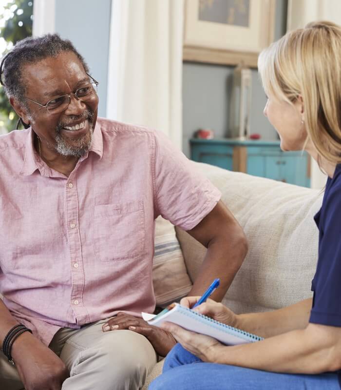 Local Therapists talking with a smiling patient to improve their wellbeing.